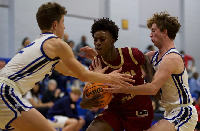 Junior guard Anthony Robinson Jr. (2) battles for possession with a pair of Maclay players in a game against Maclay on Dec. 9, 2021, at Maclay School. The Seminoles defeated the Marauders, 78-59.