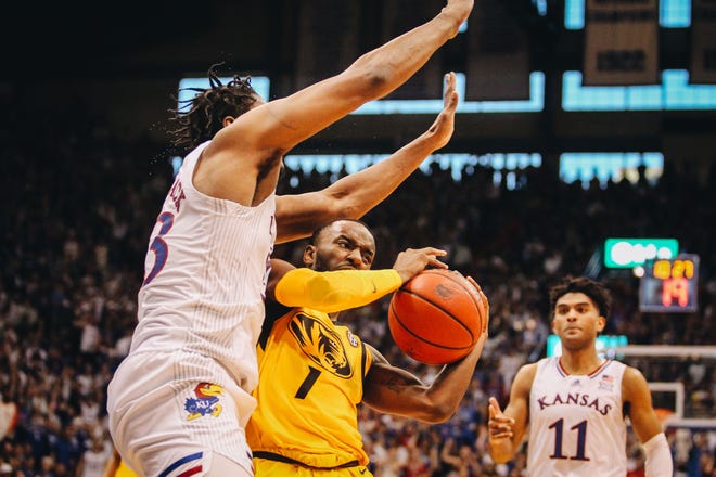 Missouri's Amari Davis (1) tries to drive on Kansas' David McCormack during the Tigers-Jayhawks Border War rivalry at the Allen Fieldhouse on Dec. 11, 2021. Davis didn't score a point in the game.