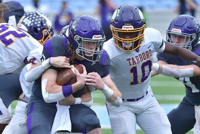 Mitchell quarterback Ty Turbyfill (2) ris brought down by Tarboro's Layton Dupree (4) on Saturday in Chapel Hill.