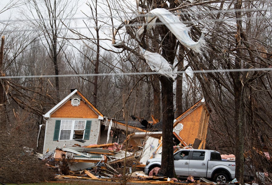 Residents along Murrell Rd. survey the damage from overnight storms that ripped through their community,  Saturday, Dec. 11, 2021 in Dickson Co. , Tenn. Tornadoes and severe weather caused catastrophic damage across multiple states late Friday.