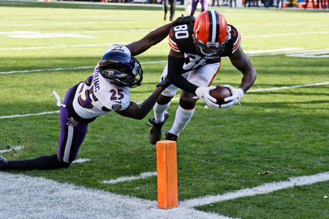 Cleveland Browns wide receiver Jarvis Landry (80) scores a 9-yard touchdown as Baltimore Ravens cornerback Tavon Young (25) defends during the first half of an NFL football game, Sunday, Dec. 12, 2021, in Cleveland. (AP Photo/Ron Schwane)