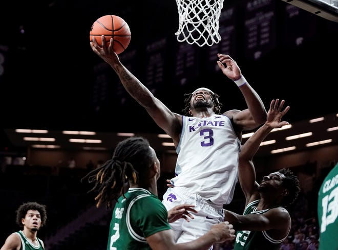 Kansas State guard Selton Miguel (3) goes to the basket against Green Bay's Kamari McGee, left, and Emmanuel Ansong (23) during the first half Sunday at Bramlage Coliseum.