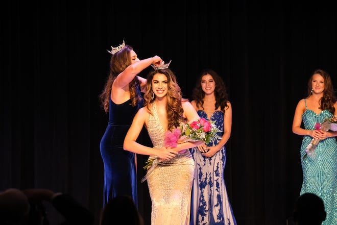 Julianna Chappell crowns Casana Fink the winner of the 2021 Miss Gainesville Scholarship Pageant on Saturday at Howard Bishop Middle School in Gainesville. [Chris Watkins/Special to The Sun]