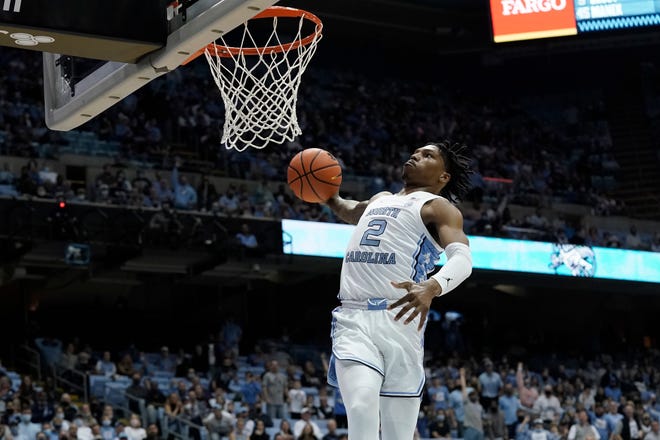 North Carolina guard Caleb Love takes off for a windmill dunk against Elon during the first half of Saturday night’s game at the Smith Center.