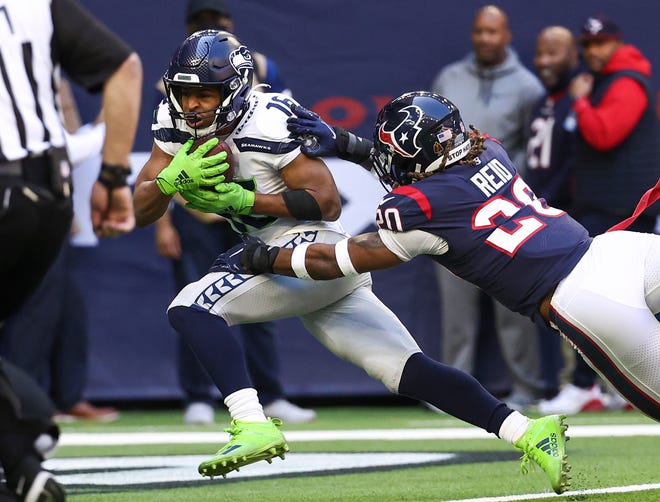 Dec 12, 2021; Houston, Texas, USA; Seattle Seahawks wide receiver Tyler Lockett (16) makes a reception for a touchdown as DUPLICATE Houston Texans safety Justin Reid (20) defends during the second quarter at NRG Stadium. Mandatory Credit: Troy Taormina-USA TODAY Sports