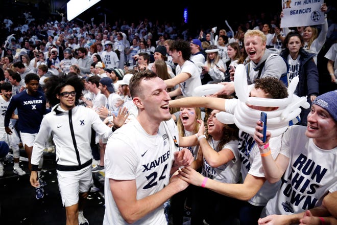 Xavier Musketeers forward Jack Nunge (24) celebrates with the student section after the second half of the 89th Annual Crosstown Shootout basketball game between the Xavier Musketeers and the Cincinnati Bearcats at the Cintas Center in Cincinnati on Saturday, Dec. 11, 2021. Xavier head coach Travis Steele improves his record in the rivalry to 3-1 as the Musketeers won 83-63. 