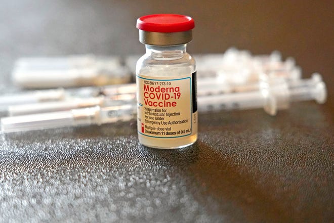 A vial filled with the Moderna COVID-19 vaccine rests by syringes waiting to be loaded by nurses from the Jackson-Hinds Comprehensive Health Center, at a vaccination station next to Jackson State University in Jackson, Miss., Tuesday, Dec. 7, 2021.
