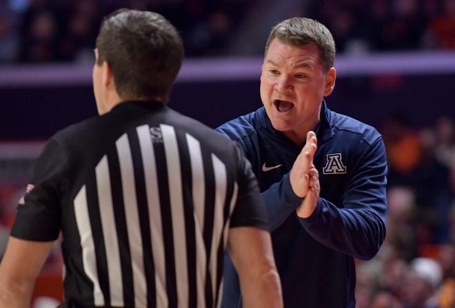 Dec 11, 2021; Champaign, Illinois, USA; Arizona Wildcats head coach Tommy Lloyd talks with an official during the first half against the Illinois fighting Illini at State Farm Center. Mandatory Credit: Ron Johnson-USA TODAY Sports