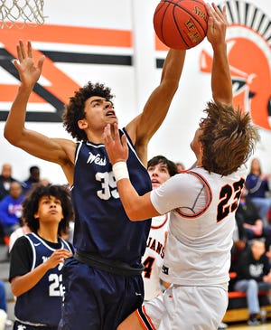 York Suburban's Ben Rohrbaugh, right, takes the ball to the hoop while West York's Jovan DeShields defends during York Suburban boys' basketball tournament championship game action at York Suburban Senior High School in Spring Garden Township, Saturday, Dec. 11, 2021. West York would win the game 52-30. Dawn J. Sagert photo