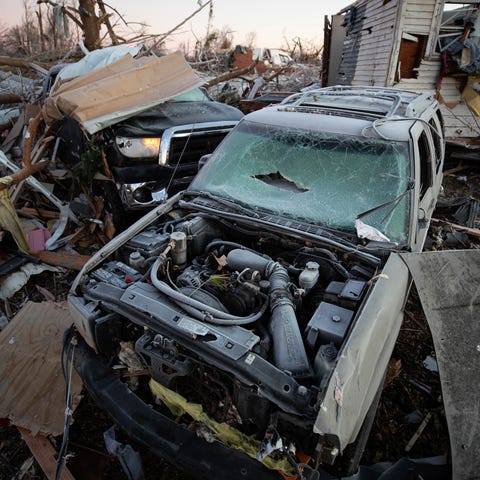 A destroyed car is among the debris left by a torn