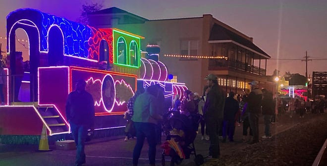 Parents and kids alike took pictures along a glistening train along Railroad Avenue during “All Is Bright.”