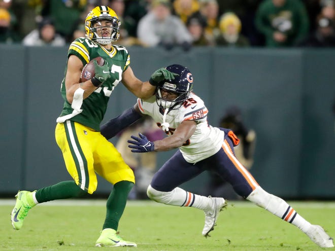 Packers wide receiver Allen Lazard (13) runs after a catch against Bears cornerback Artie Burns on Sunday.