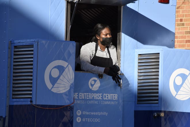 A food truck worker watches the opening of The Enterprise Center of New Jersey, the state's first Minority Business Development Agency office, in Camden, N.J., on Dec. 13, 2021.