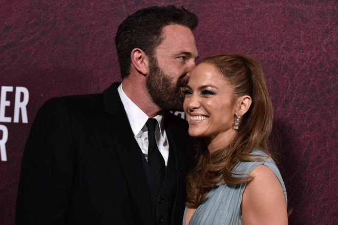 Ben Affleck, left, and Jennifer Lopez arrive at the premiere of "The Tender Bar" on Sunday, Dec. 12, 2021, at the TCL Chinese Theatre in Los Angeles.