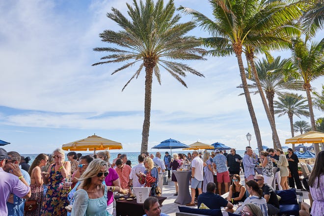 Guests gather at the 2021 Palm Beach Food and Wine Festival's "Grillin' n' Chillin'" cookout at the Eau Palm Beach resort.