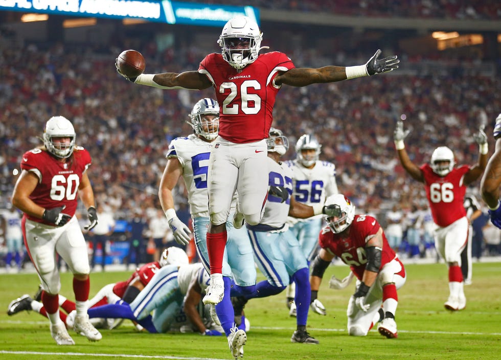 Cardinals' Eno Benjamin (26) jumps into the end zone to celebrate a touchdown against the Cowboys during the second quarter at the State Farm Stadium in Glendale, Arizona, on Aug. 13, 2021.