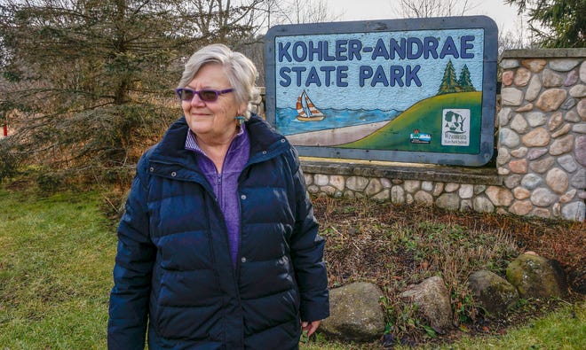 Mary Faydash stands near the entrance of Kohler-Andrae State Park, Tuesday, Dec. 14, 2021, in Sheboygan. Faydash is part of a group that is opposed to Kohler Co. building a golf course adjacent to the park.