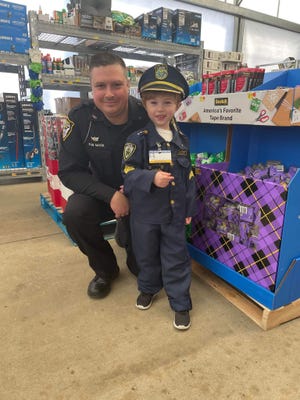Alliance Police Officer Sean Mark took part in a recent Shop with a Cop event that included 4-year-old Eagan Randolph, right.