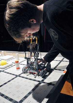 Dylan Deerburn, a student at Chippewa Jr./Sr. High School, checks the programing of his robot before his match. Most of the robots are made out of items such as LEGOs and 3-D printed items.