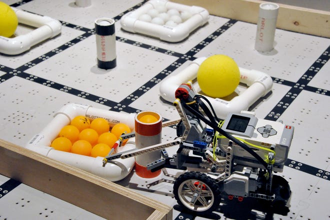 A robot collects pingpong balls to gain points in a match of Bot Ball, which is one of the many competitions offered by the National Robotics Challenge. The group was established in 1986 and holds national competitions for robotics teams.