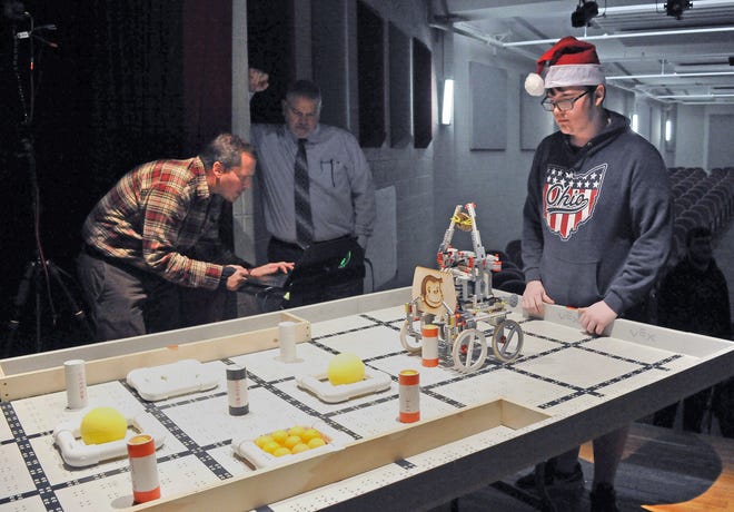 Aiden Raber (right) of Chippewa gives his robot one last pre-programmed test before competition begins. Norwayne computer teacher Paul Klotzle (left) and Norwayne Superintendent Kevin Leatherman review the camera set up before the matches of Bot Ball begin.