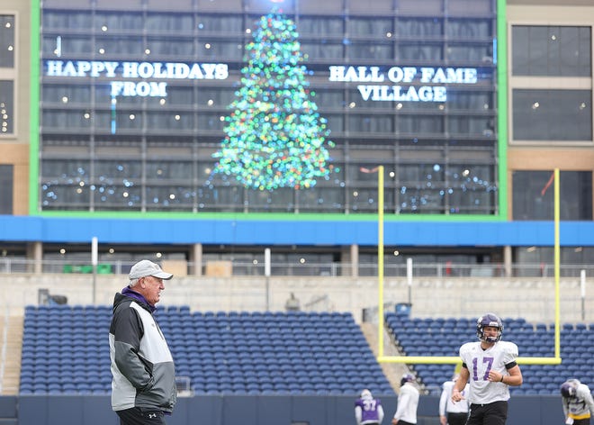 University of Mary Hardin-Baylor head coach Pete Fredenburg watches warmups during a practice Wednesday afternoon at Tom Benson Hall of Fame Stadium in Canton. Mary Hardin-Baylor and North Central College are playing Friday in the Stagg Bowl.