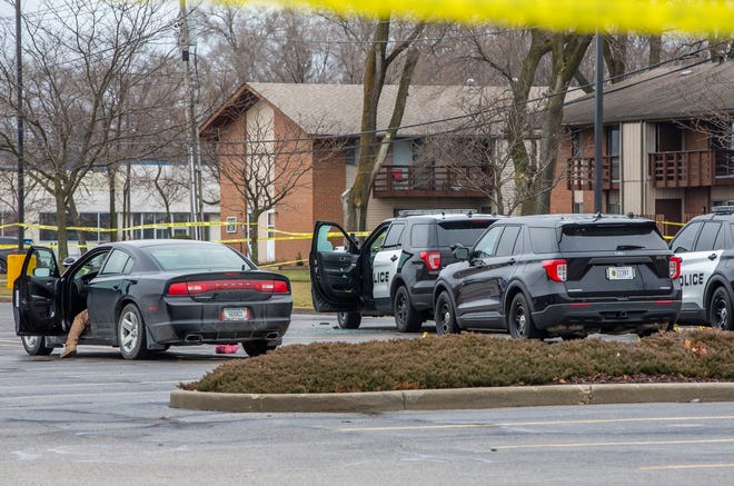 A police vehicle is seen with a broken window as police investigate after a fatal shooting by an officer in a parking lot near West Hively Avenue on Wednesday in Elkhart.