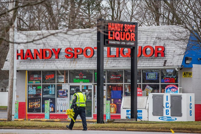 Police investigate a crime scene, which included an incident at Handy Spot Liquor, after a fatal shooting by an officer in a parking lot near West Hively Avenue on Wednesday, Dec. 15, 2021, in Elkhart. 
