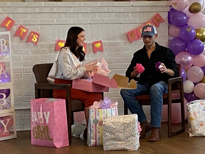 From left: Desiree Williams and Michael Tyler Scism celebrate their baby shower at the community center in Waco.