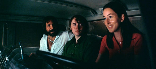 Alana (Alana Haim, right) and Gary (Cooper Hoffman) go on a full-throttle escapade with Jon Peters (Bradley Cooper), boyfriend to Barbra Streisand.