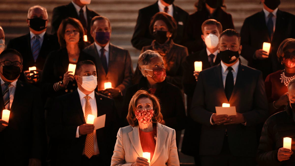 Speaker of the House Nancy Pelosi and lawmakers participate in a moment of silence for the 800,000 American lives lost to COVID-19 on Dec. 14, 2021 in Washington, DC.