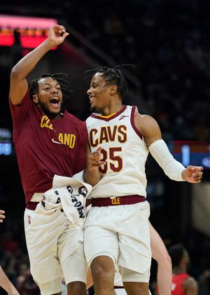 Cavaliers guards Isaac Okoro, right, and Darius Garland celebrate during a victory over the Houston Rockets earlier this season. [Tony Dejak/Associated Press]