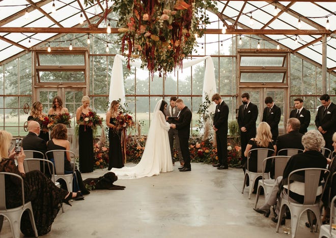 Massive floral installations served triple-duty at Erin and Aaron Gutentag’s Jorgensen Farms Oak Grove wedding.