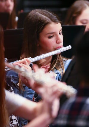 Glen Rose eighth-grader Tessa Brannock plays the flute during the Glen Rose Band Christmas Concert Tuesday night at the GRHS Auditorium.