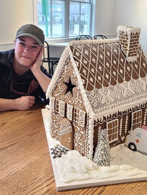 Kate Rousselle with the Bean Counter's gingerbread house entry, “The House that Bean, Dan and Doc Built.”