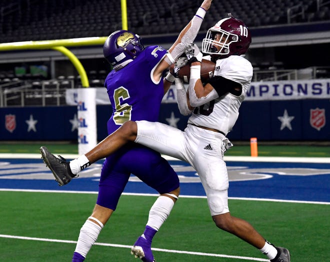 Hawley wide receiver Chandlin Myers receives a pass despite the efforts of Shiner defensive back Drew Wenske during Wednesday's Class 2A Div. I state championship game against Shiner in Arlington. Final score was 47-12, Shiner.