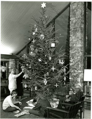 This undated Edward L. Dupuy photograph from the Swannanoa Valley Museum's collections shows people gathered around a Christmas tree, but not where it was taken.