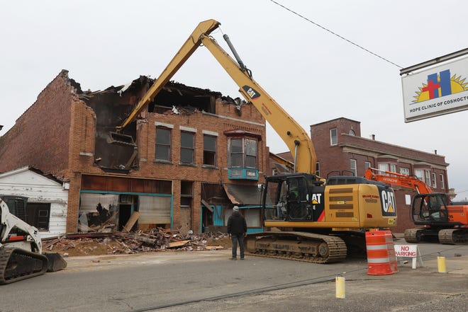 An excavator takes a chunk out of the former Chinese restaurant at 134 S. Sixth Street in Coshocton on recently. The building is being demolished to make way for parking for adjacent Coshocton Behavioral Health Choices.
