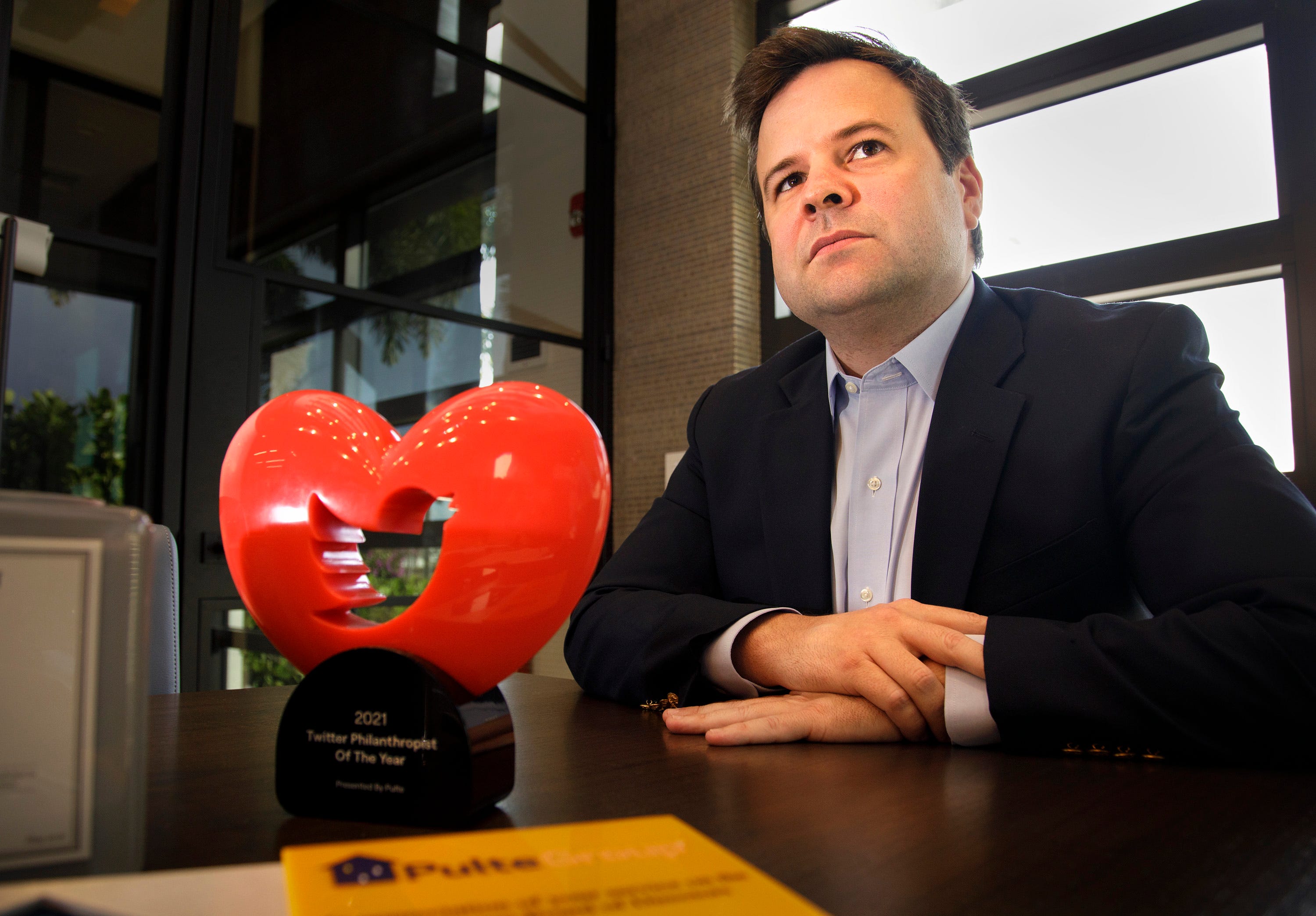 Bill Pulte with the Twitter Philanthropist of the Year trophy in his offices in Boca Raton, Florida, on Dec. 13, 2021. Pulte is known globally as a Twitter philanthropist. He has been a strong supporter of efforts to raise money for Oxford families.