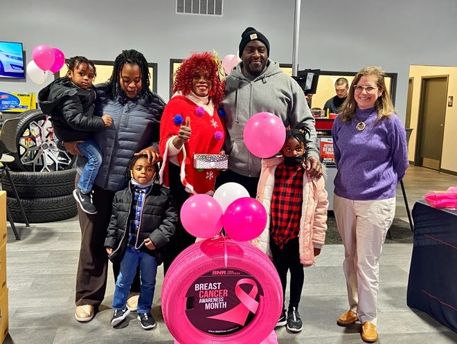 Paula Davis with some of her family members at her Breast Cancer Survivor Award Ceremony located in RNR Tires, Dec. 11, 2021