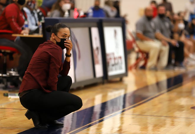 Deming High Lady 'Cat Coach Kim Garcia takes in the action.