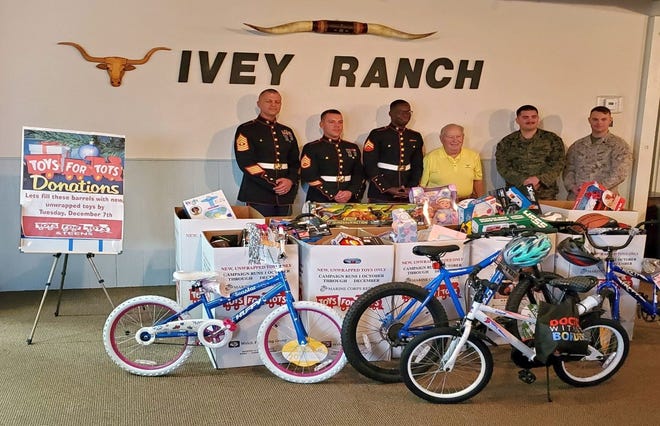 1stSgt Dan Julian, SSgt Riley Hogue, Cpl Jamal Lewis, James Litman, Sgt Anthony Warboys and SSgt Adam Scroggins show off the record efforts of the Ivey Ranch HOA toy drive.