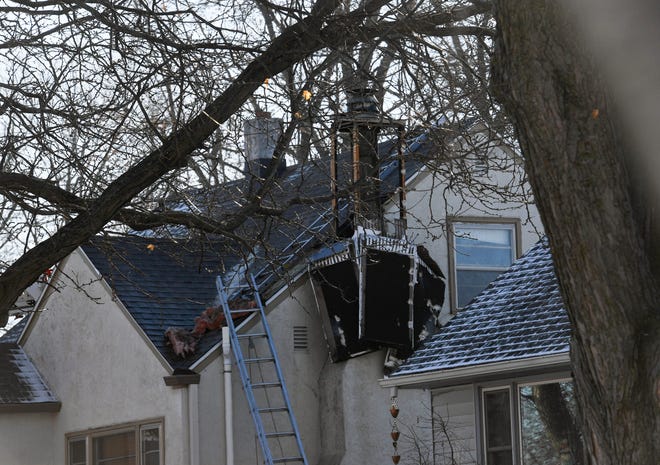 A fire-damaged chimney is seen at a house fire call on Thursday, December 16, 2021 on Frederick Drive in Sioux Falls.
