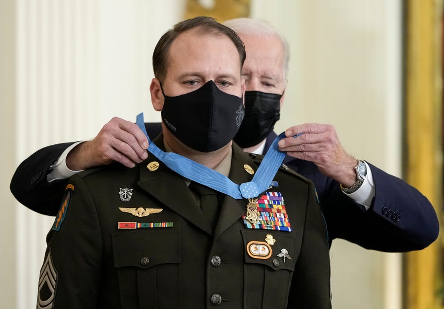 U.S. President Joe Biden awards the Medal of Honor to Army Master Sgt. Earl Plumlee in the East Room of the White House December 16, 2021 in Washington, DC. Plumlee, an Army Green Beret, is receiving the medal for his efforts to repel a suicide attack by Taliban fighters at Forward Operating Base Ghazni in Afghanistan in August 2013. (Photo by Drew Angerer/Getty Images)