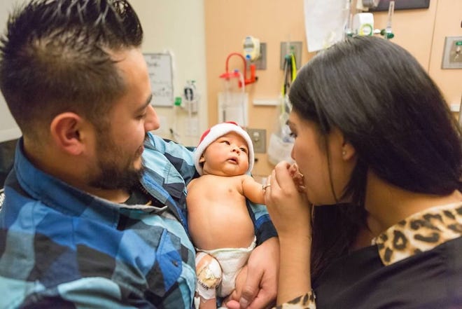 Jesenia and Hector Perez with baby Sebastian.
