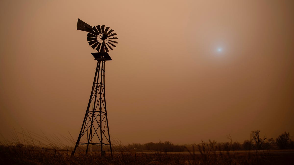 The dust from heavy winds obscures the sun in Hodgeman County in Jetmore, Kans., Wednesday, Dec. 15, 2021.