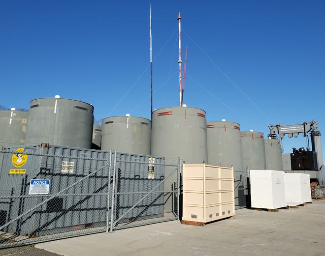 Dry casks hold spent fuel rods in storage on a pad at Pilgrim Nuclear Power Station in Plymouth in December 2020. A proposal by the company decommissioning the closed plant to dump up to 1 million gallons of treated radioactive water into Cape Cod Bay has drawn opposition in the region.