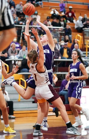 Bloomington South’s Carlie Pedersen (3) drives to the basket against Bloomington North’s Emma McDivitt (1) during the Bloomington North-Bloomington South game at North Thursday evening.