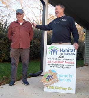 Construction Chairman Bill Meyers gets special recognition from HFHCC Executive Director Burney Drake during the Habitat for Humanity Dedication Ceremony at the house they built in Vermont Village on Gidney Street in Shelby Thursday afternoon, Dec. 16, 2021.