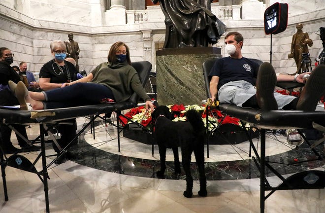 Governor Andy Beshear and Lt. Gov. Jacqueline Coleman donate blood in the capitol rotunda on Friday, December 17, 2021